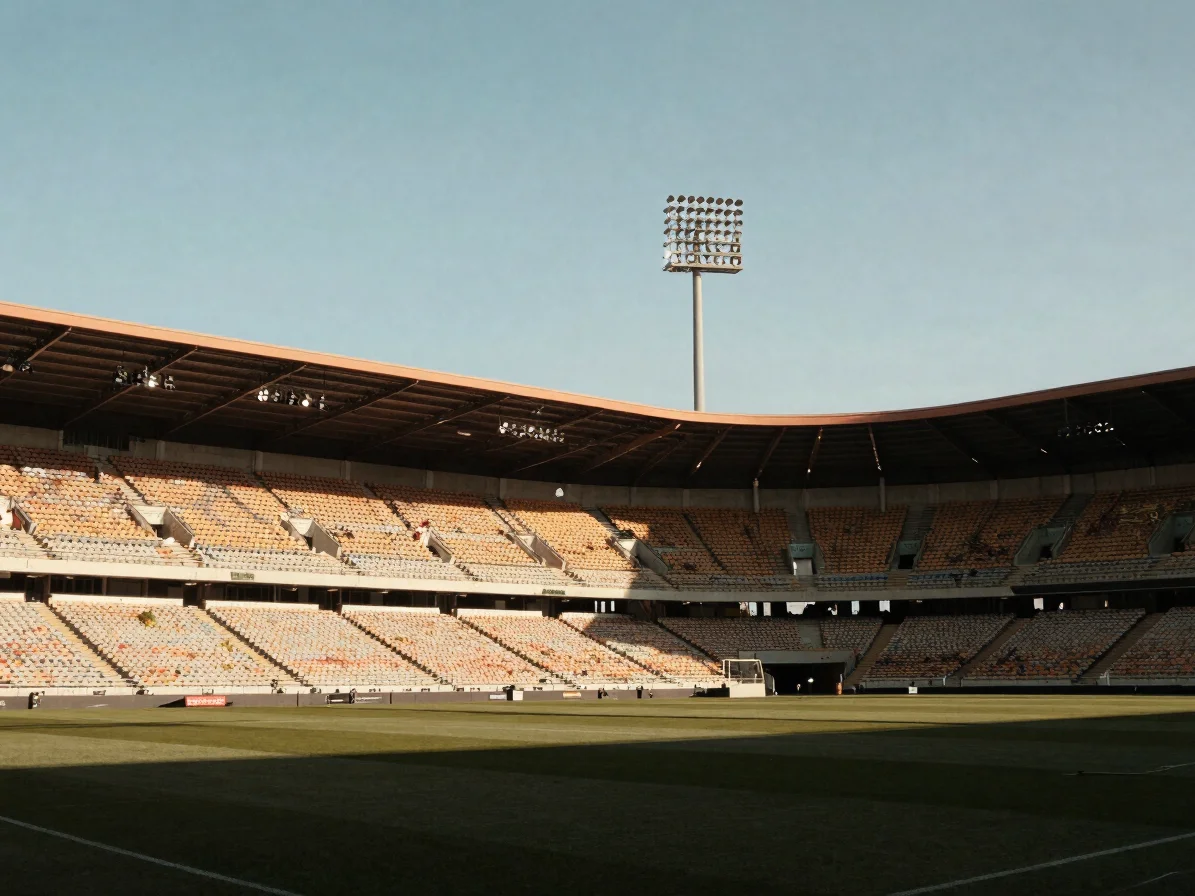 Wide stadium environment under floodlight-warm daylight, empty se